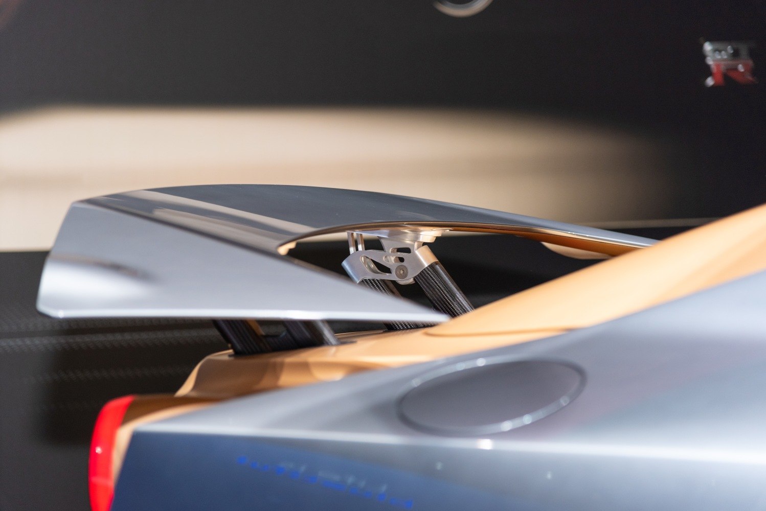 Close-up of rear carbon fiber spoiler with aerodynamic supports