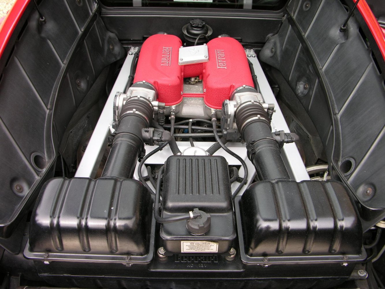 Red intake manifolds and dual airboxes in a high-performance engine bay