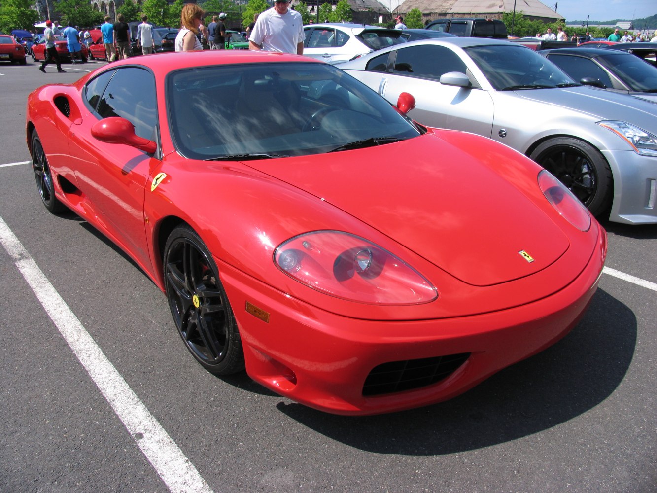 Red sports coupe front side with aerodynamic shape and black wheels