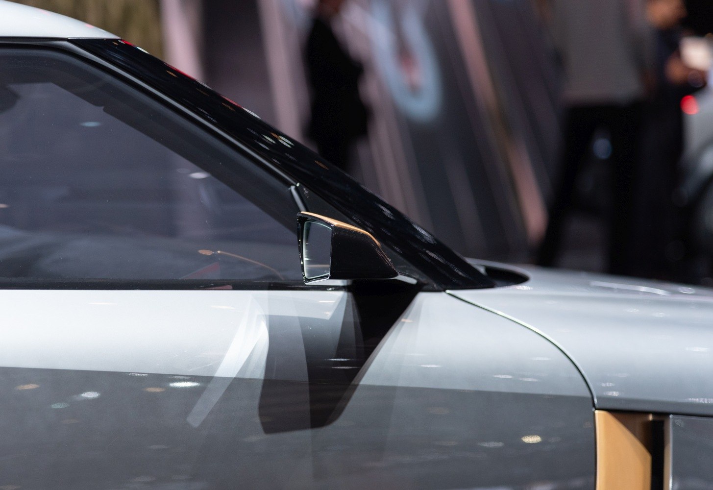 Sleek side mirror and window design of a modern sports car
