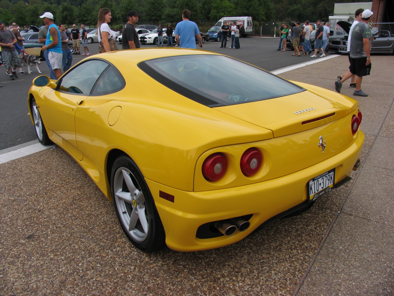 Yellow sports car rear with dual exhausts and round taillights