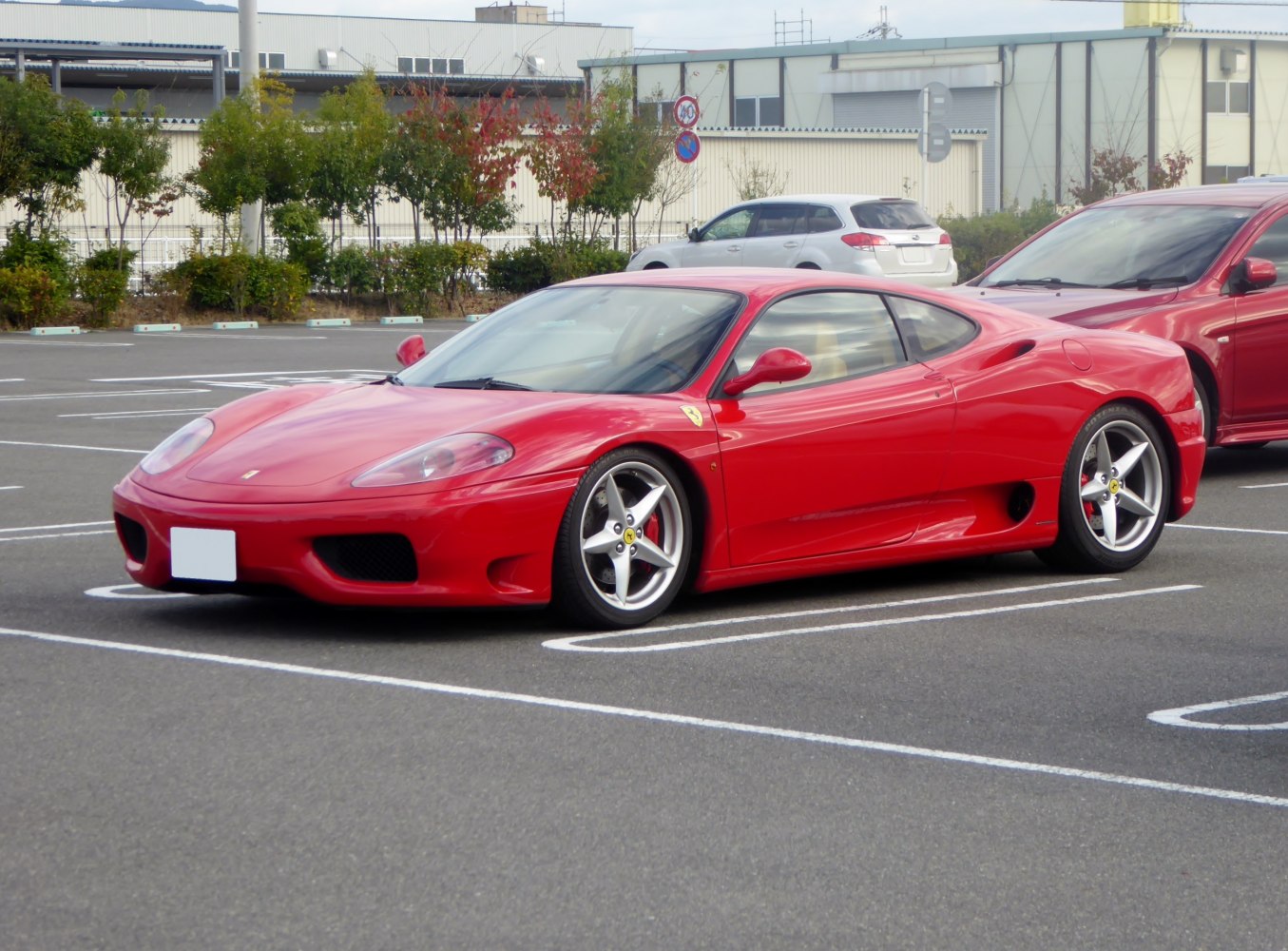 Red sports coupe with sleek aerodynamic body and five-spoke alloy wheels