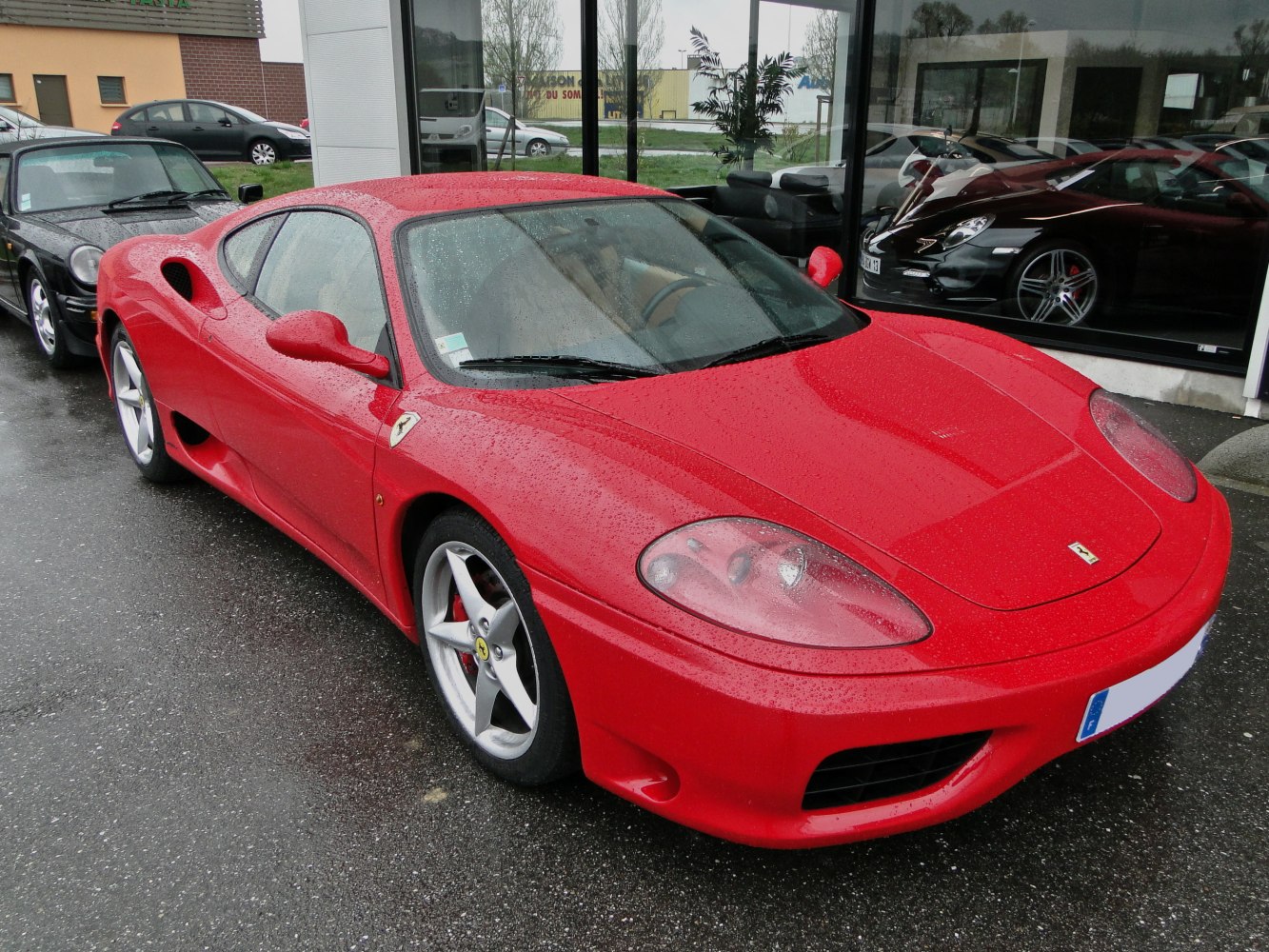Red sports coupe with distinctive headlights and aerodynamic side air intakes