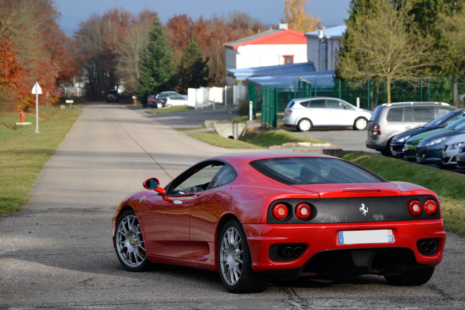 Rear view of red sports coupe with quad exhaust and round tail lights