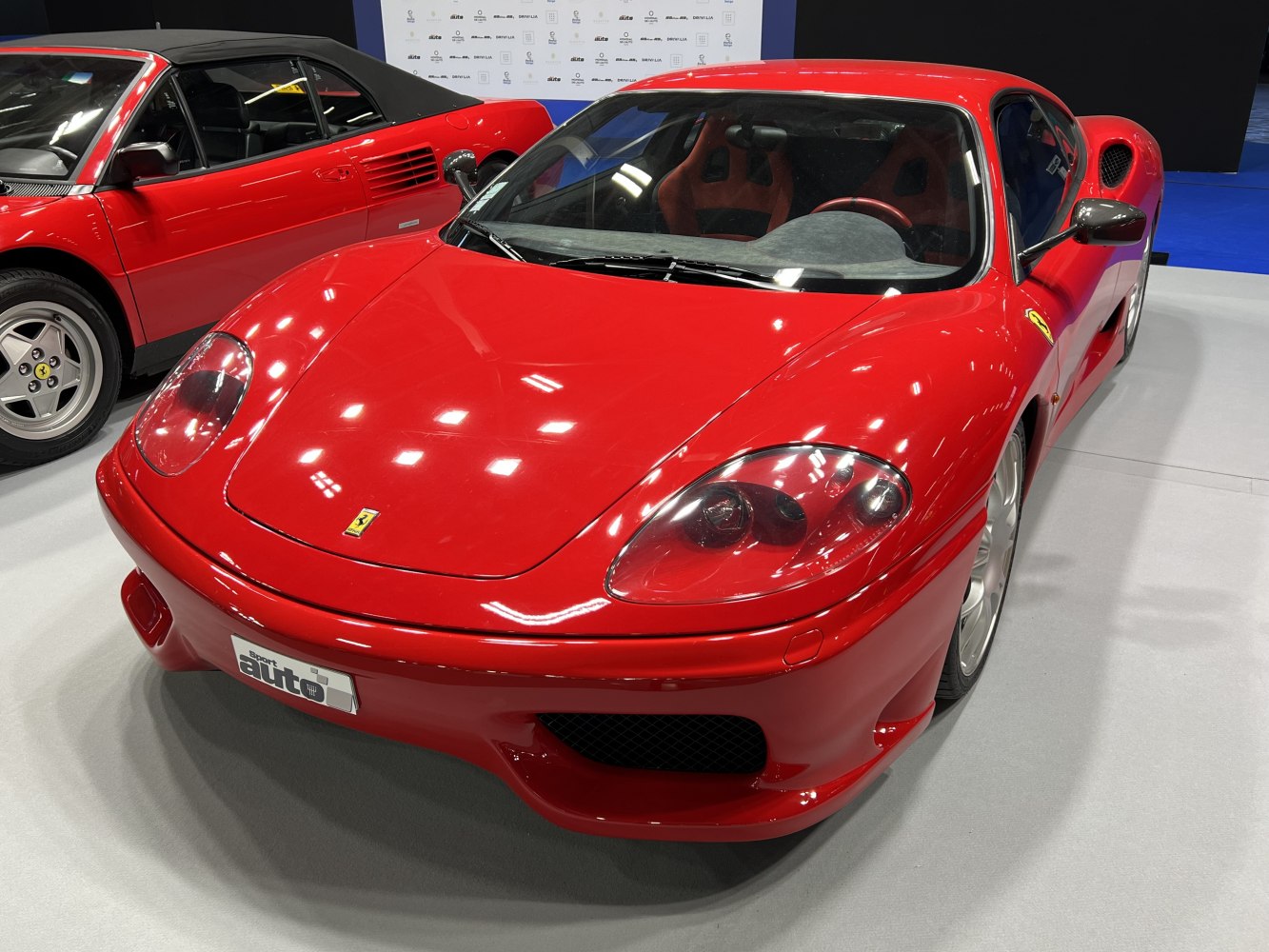 Red sports car front with aerodynamic design and detailed headlights