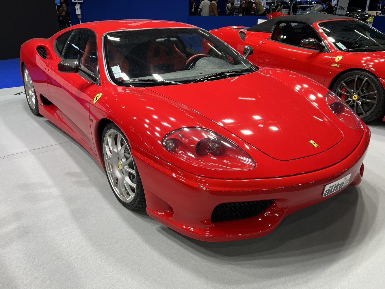 Red sports coupe with sleek aerodynamic body, alloy wheels, and distinctive front view.