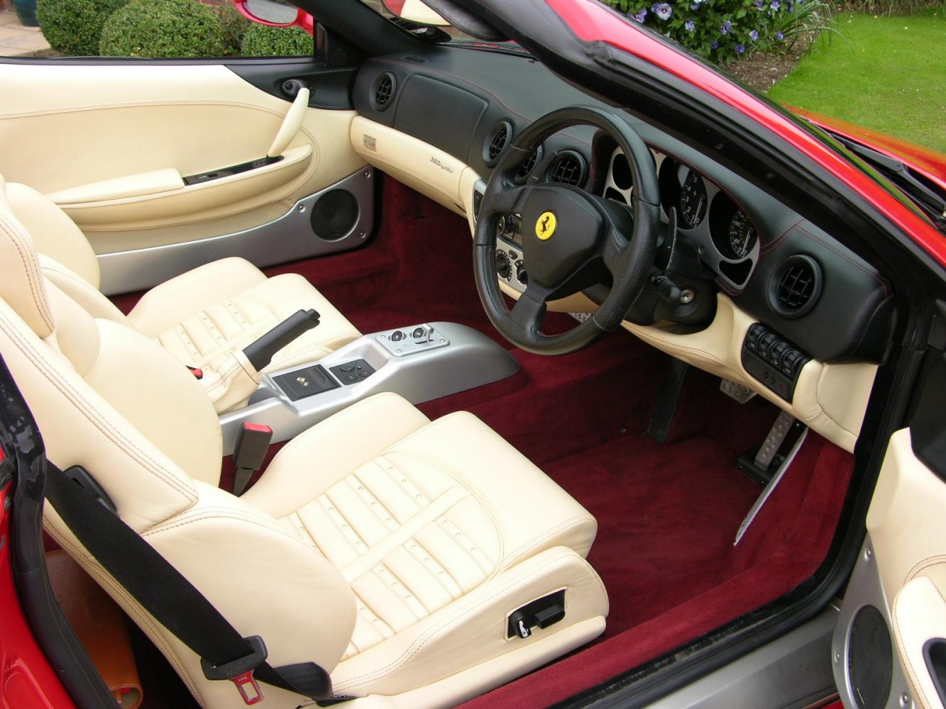 Luxury beige leather seats, red carpet, black steering wheel