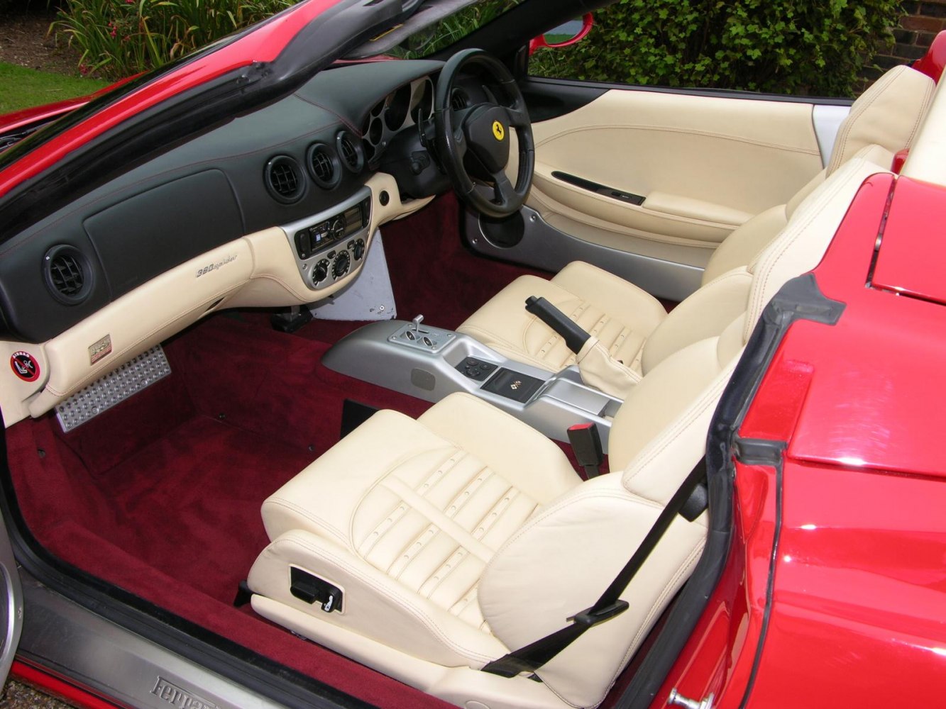 Beige leather seats and sporty dashboard in a convertible interior