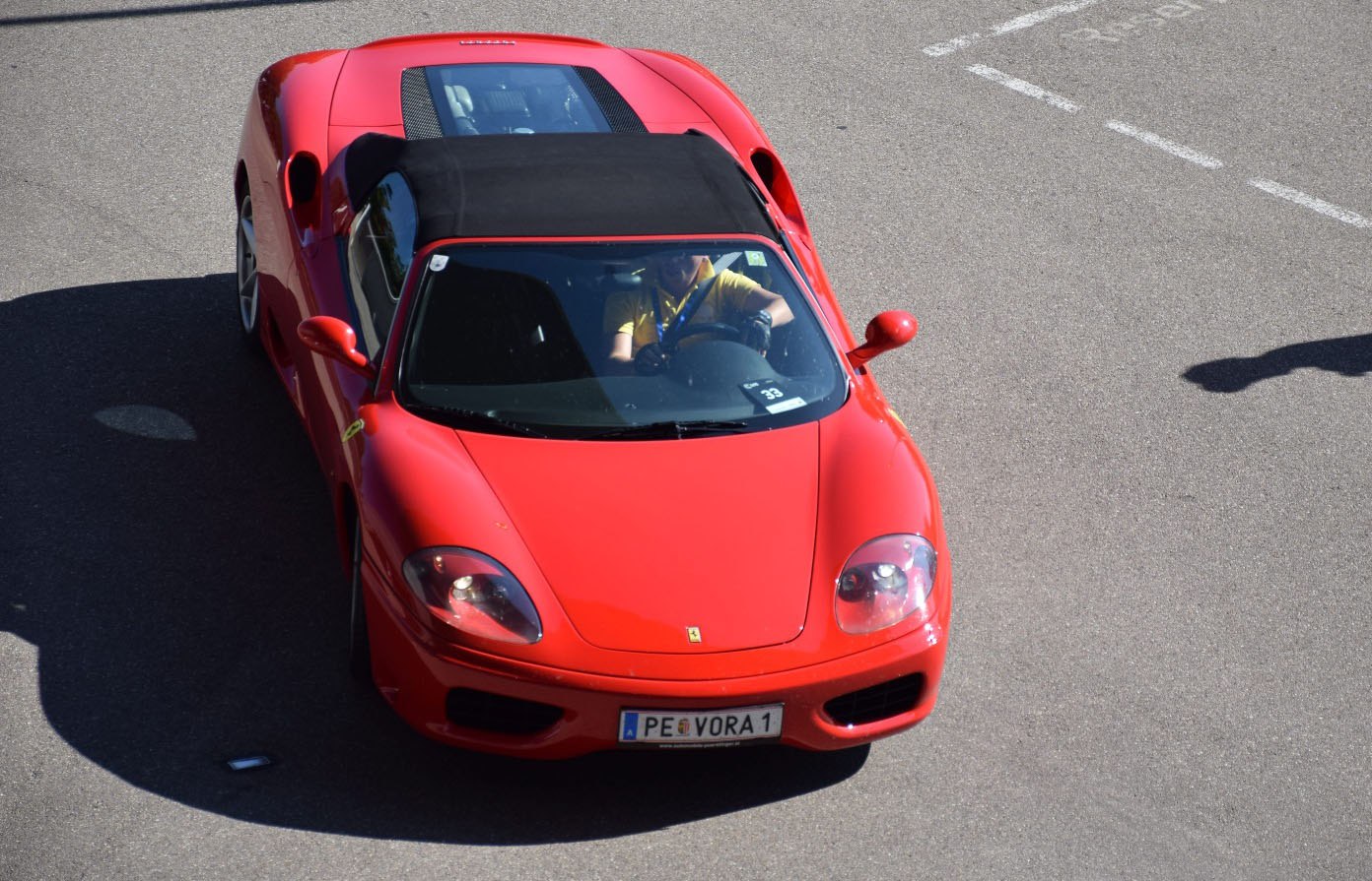 Convertible sports car with black soft top, aerodynamic front