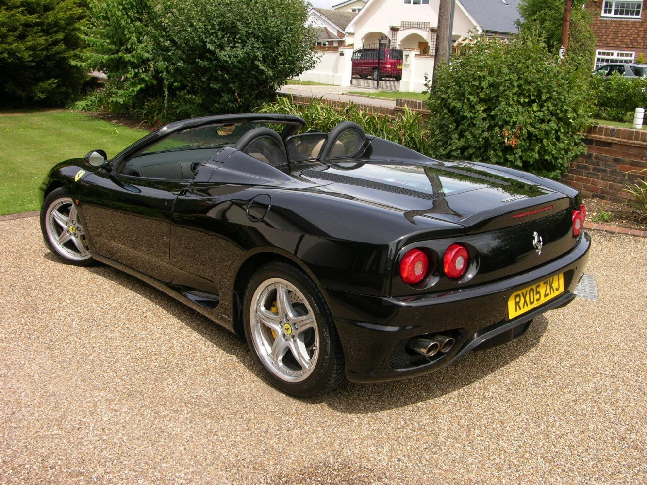 Black convertible sports car with dual round taillights and aerodynamic curves