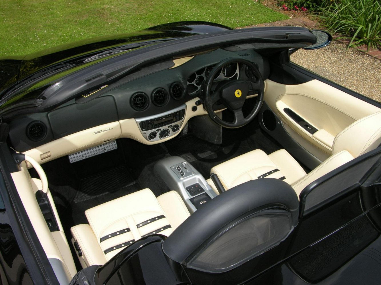 Convertible sports car interior with dashboard and leather seating