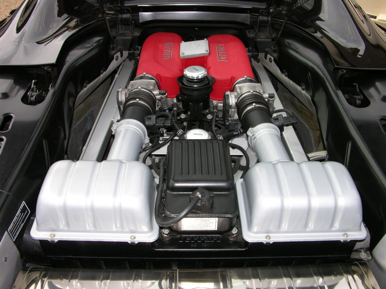 Red intake manifolds and mid-mounted engine layout.