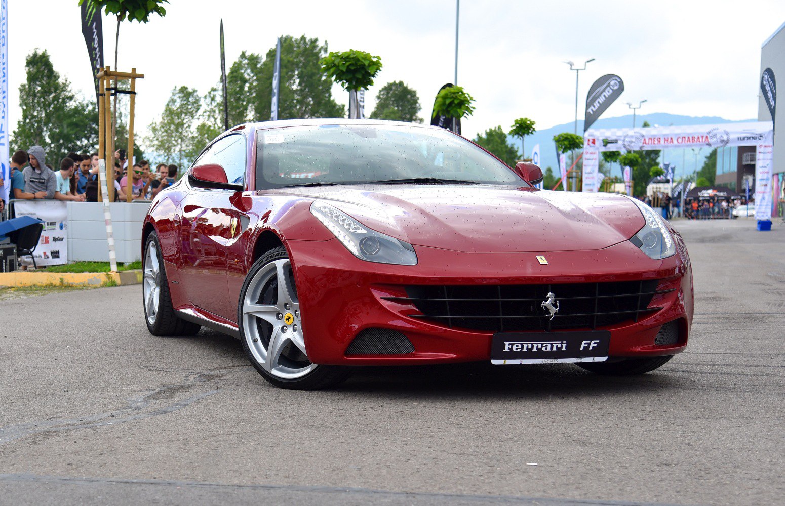 Red sports car front with aerodynamic grille and slim headlights