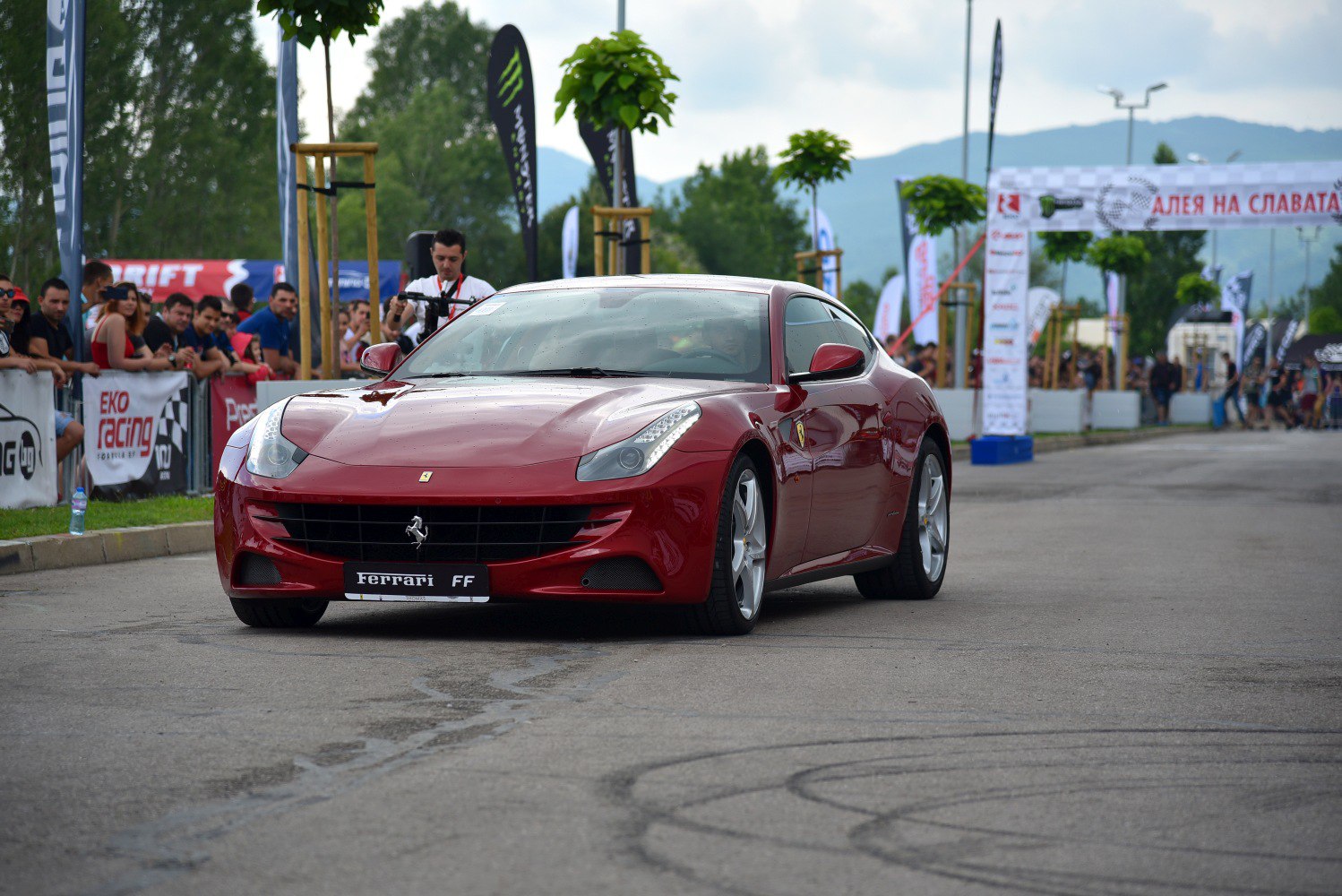 Front view of red luxury sports coupe with distinctive Ferrari grille and headlights.