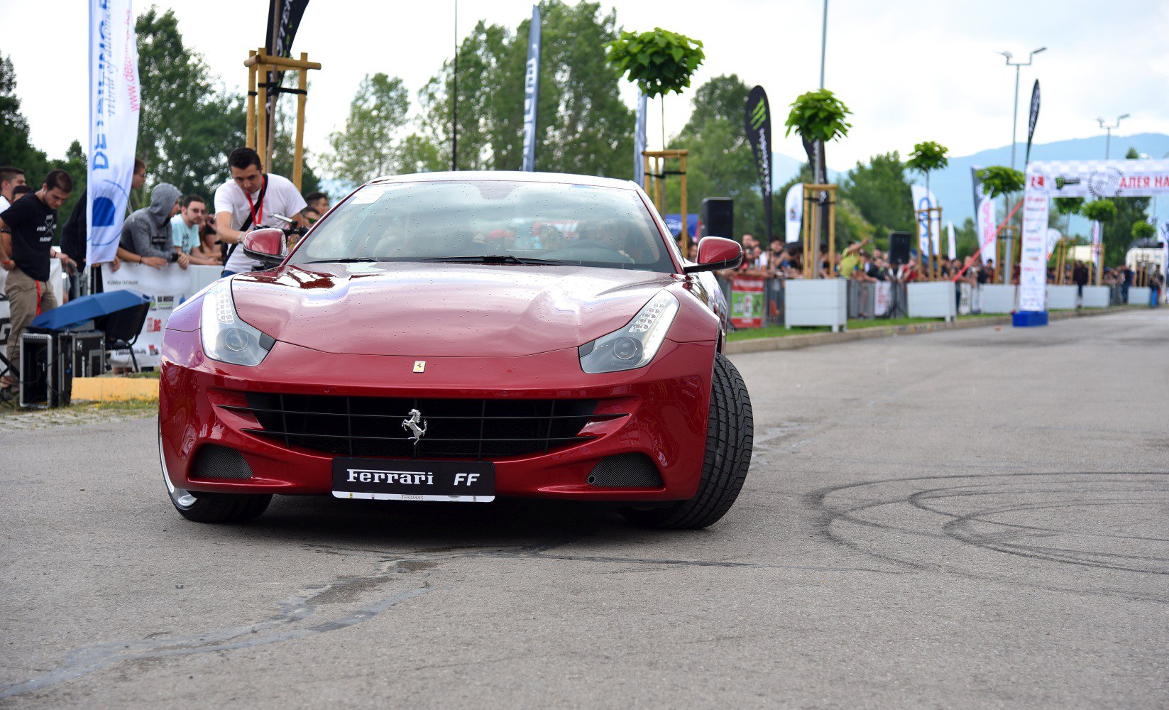 Front view of a sleek luxury coupe with aggressive headlights and grille