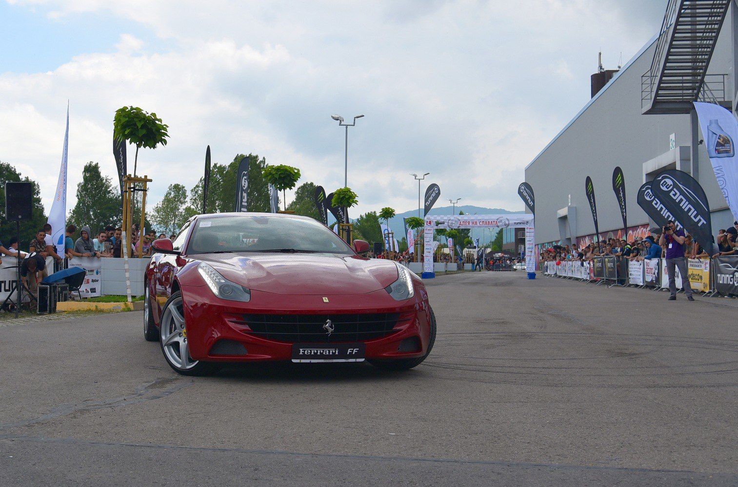 Front view of red sports car with LED headlights and grille design