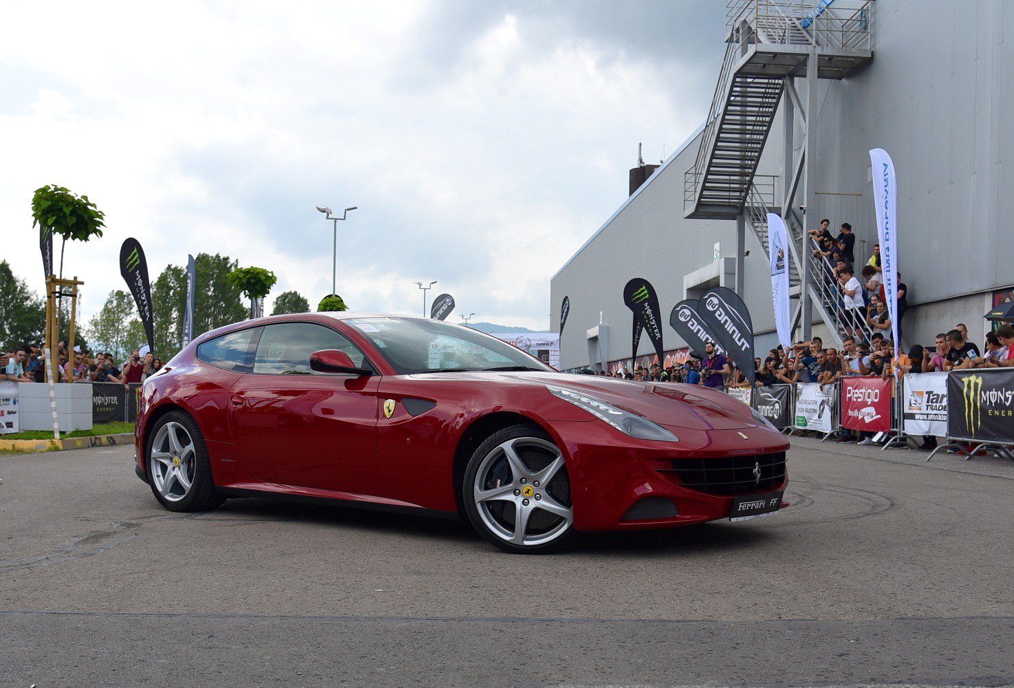 Front-side view of sleek sports coupe with alloy wheels.