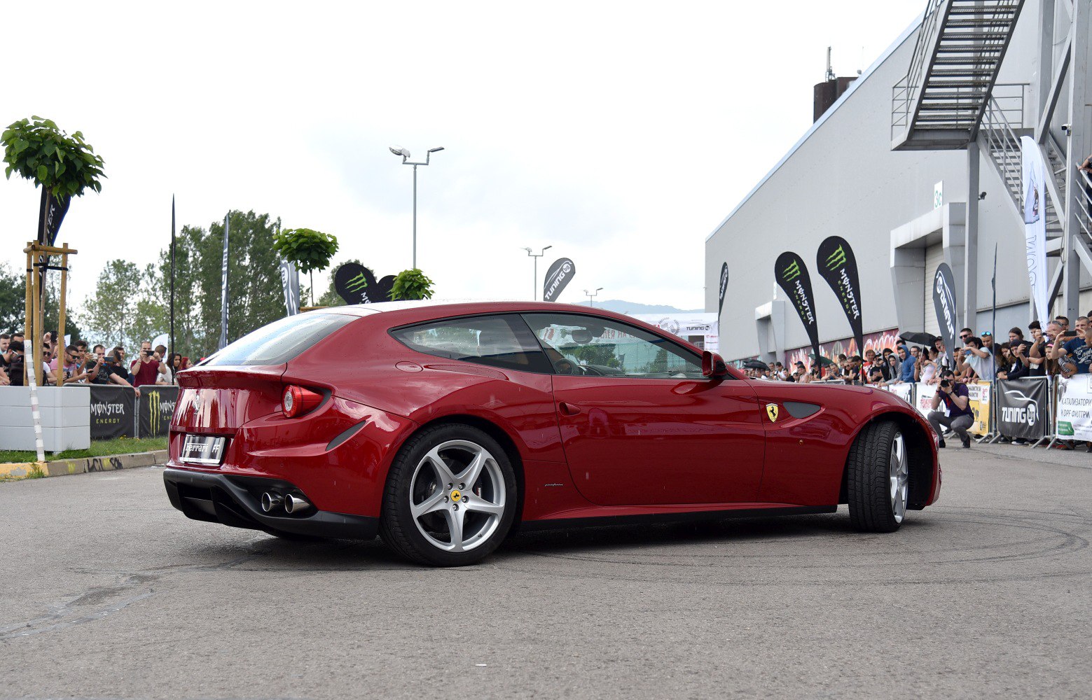 Red sports hatchback with distinctive twin exhaust and alloy wheels