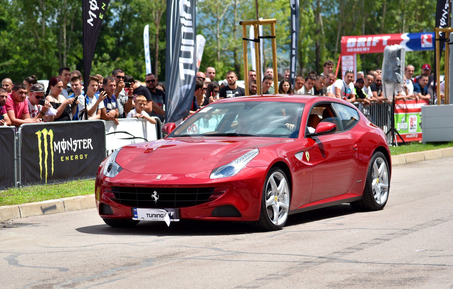 Red Ferrari FF front three-quarter view with crowd