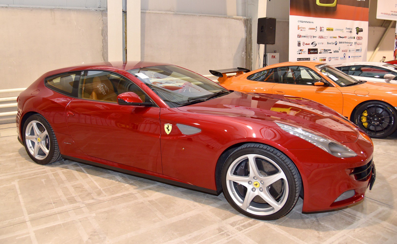 Red hatchback with five-spoke alloy wheels and sporty side profile