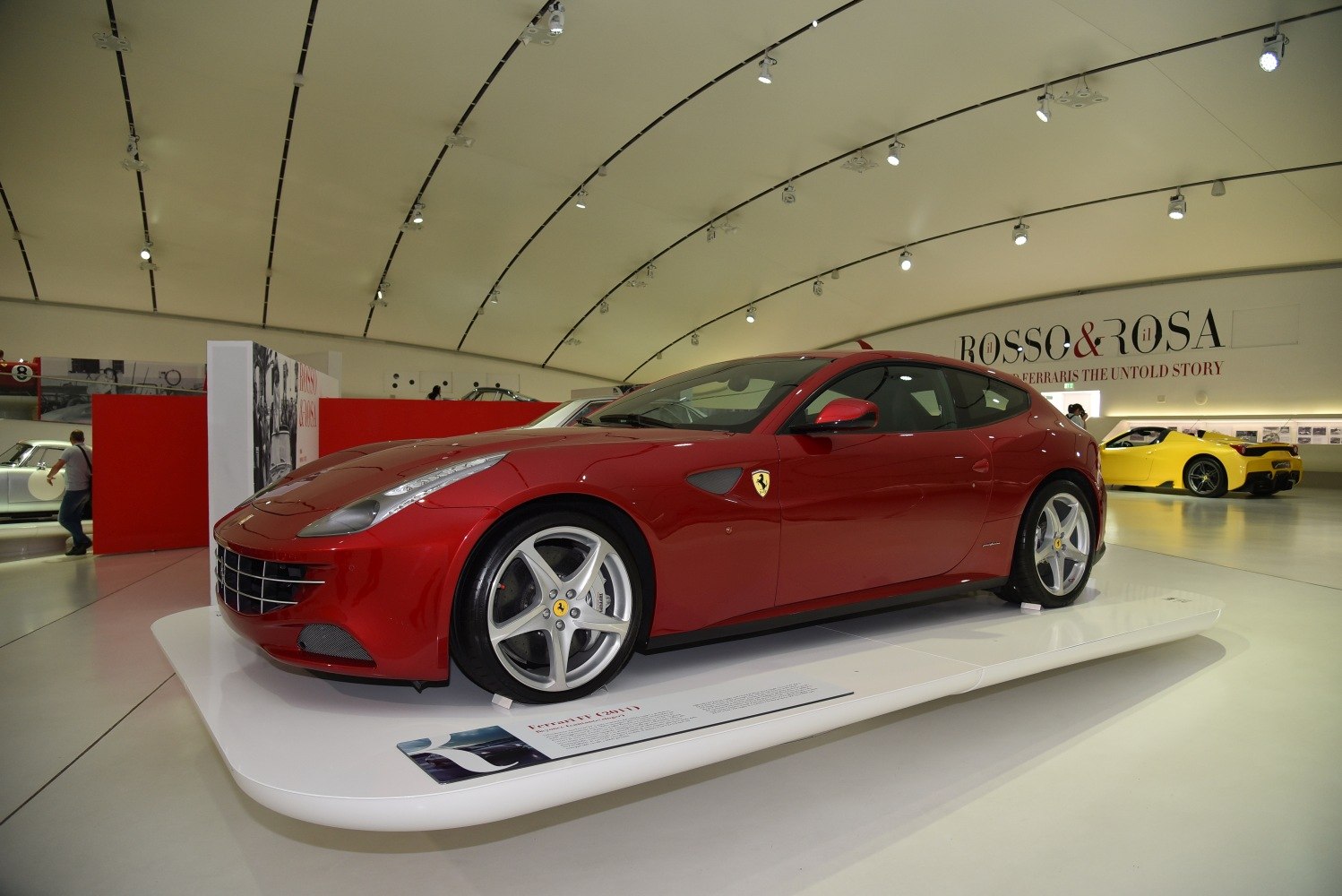 Red luxury 4-seater coupe with prominent front profile and five-spoke wheels