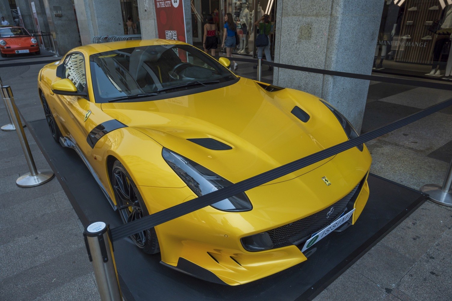 Yellow sports car front with aerodynamic vents and sharp headlights