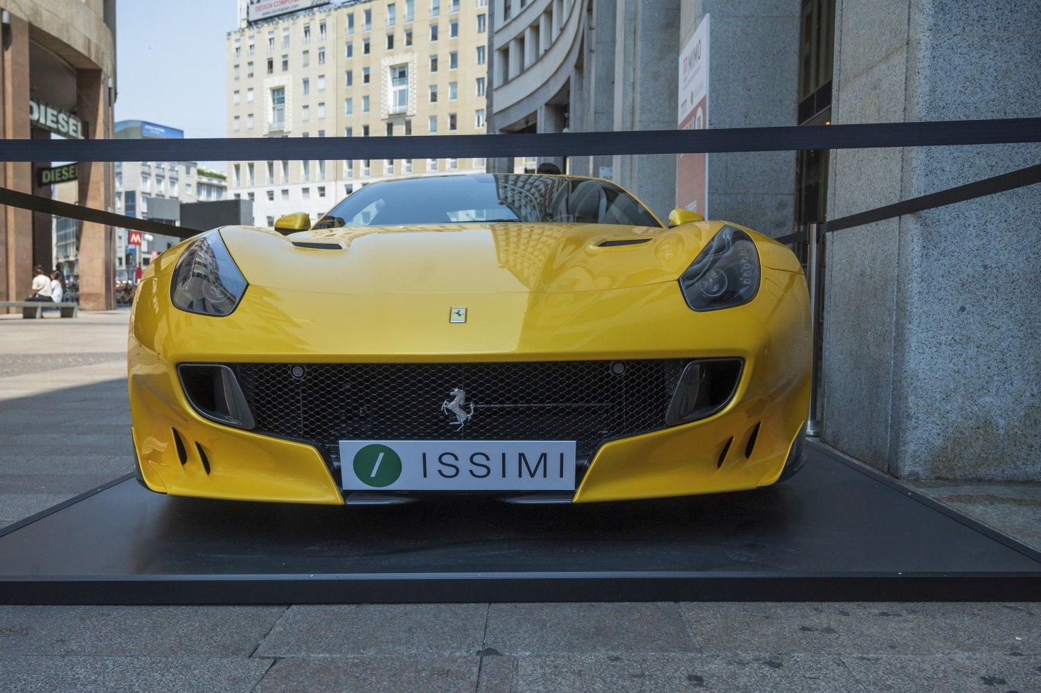Front view of a yellow sports car with aggressive grille and sleek headlights