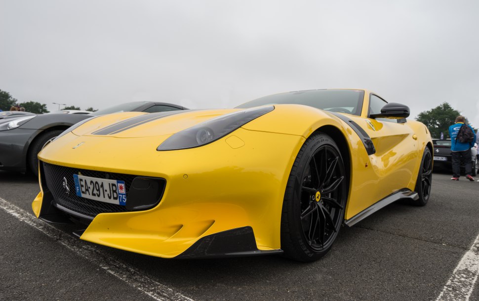 Yellow sports coupe with aerodynamic front and black alloy wheels