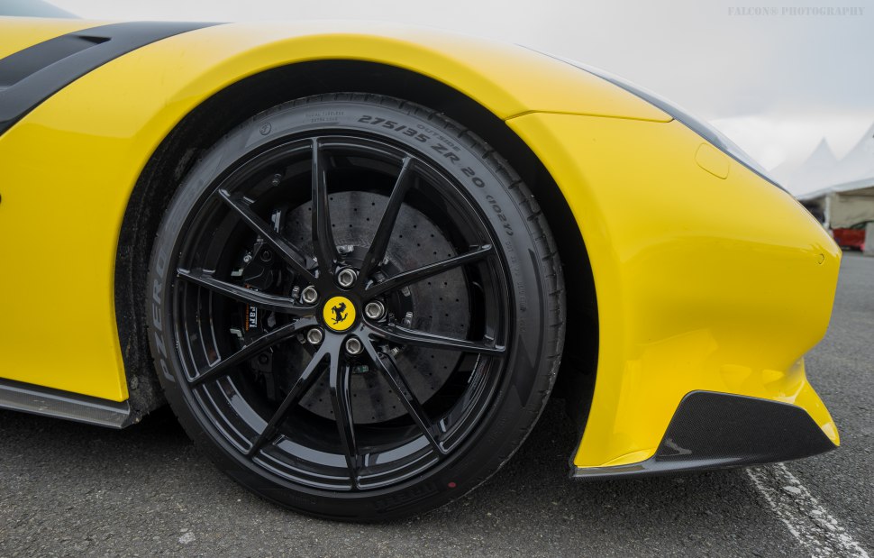 Black alloy wheel with drilled brake disc and yellow fender detail