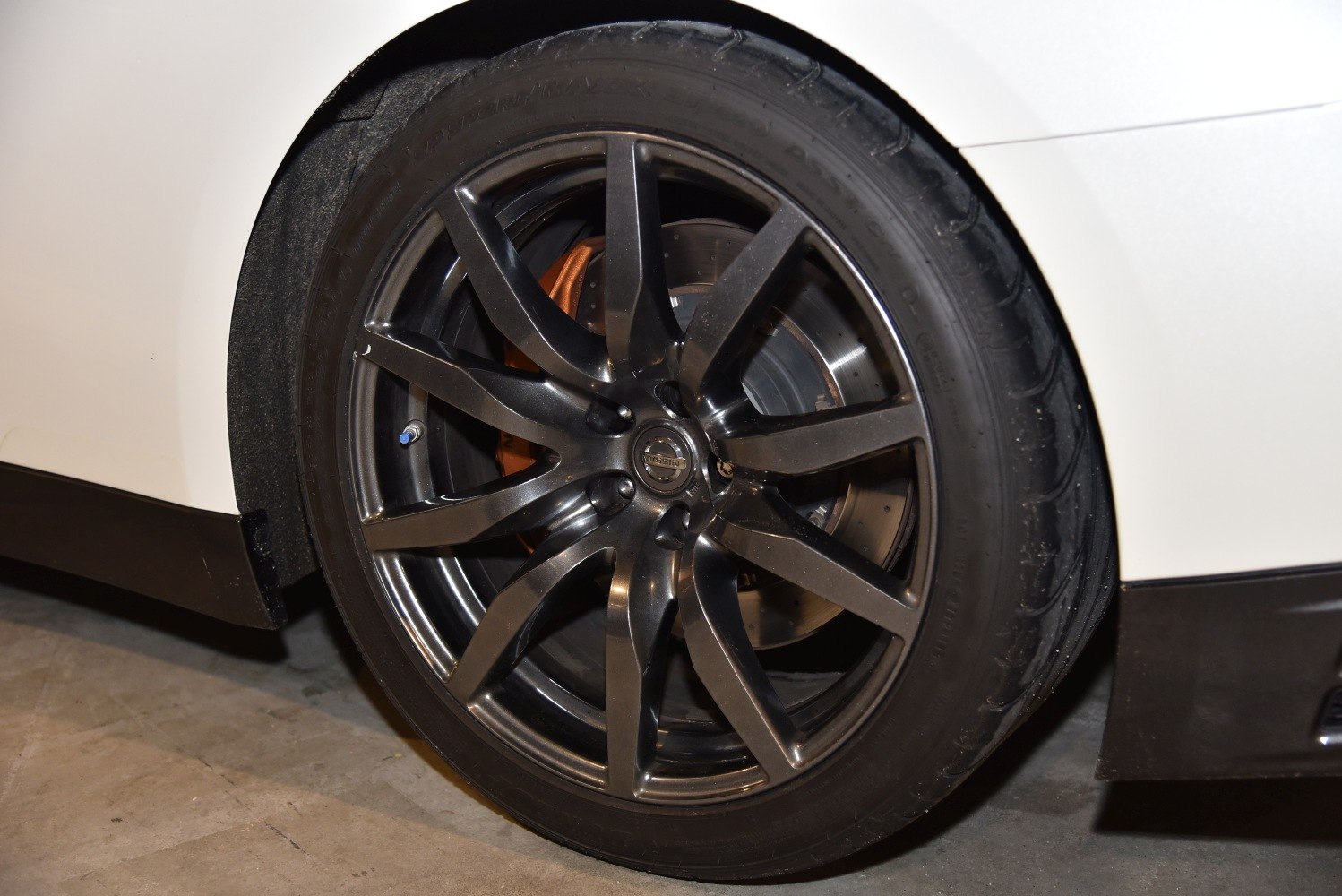 Black multi-spoke alloy wheel with brake disc and caliper