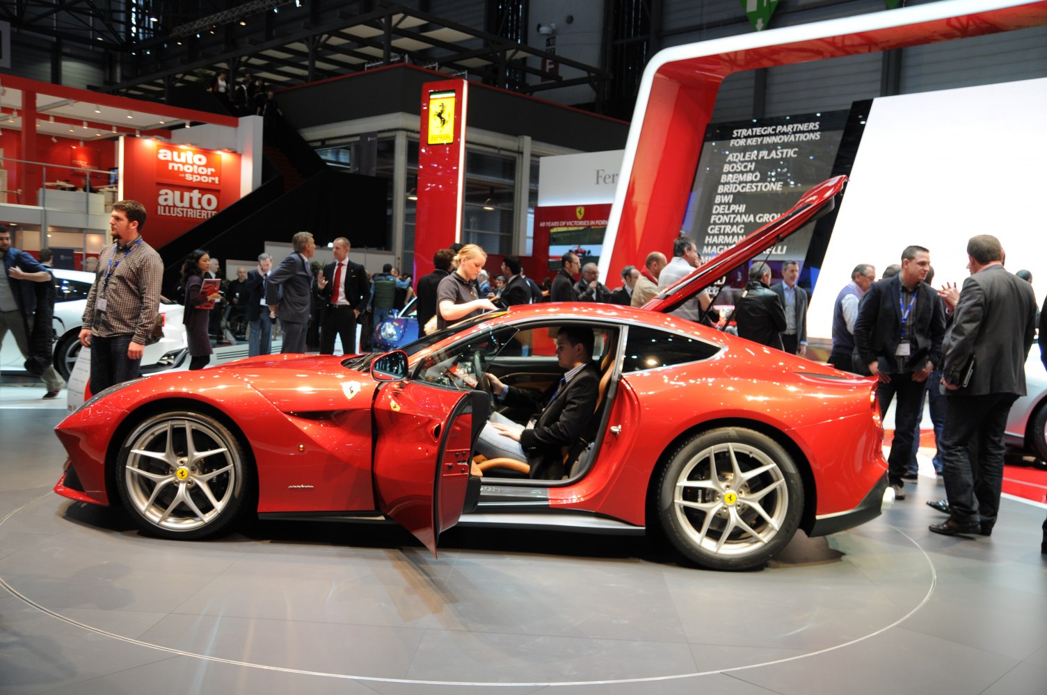 Red sports coupe with open door and rear hatchback