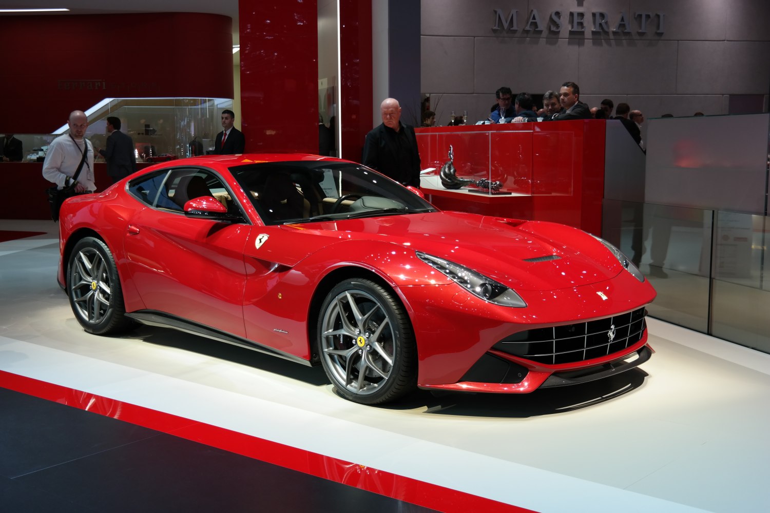Sporty red coupe with sharp headlights and alloy wheels