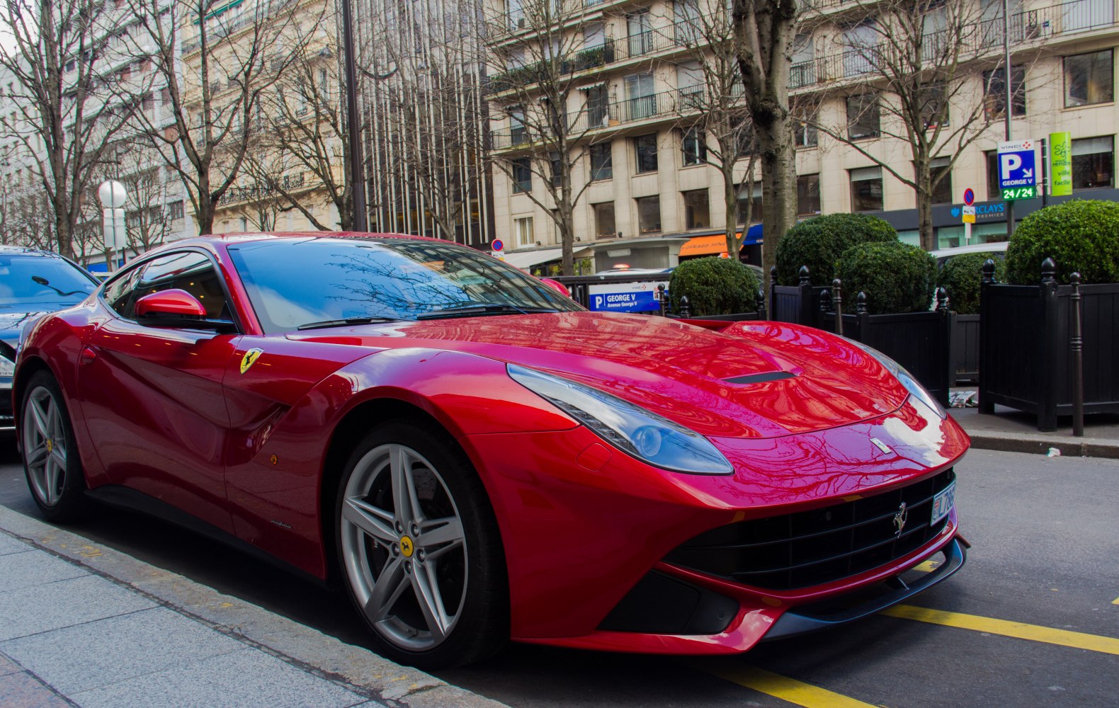 Front-side red sports coupe with sharp headlights and aerodynamic curves