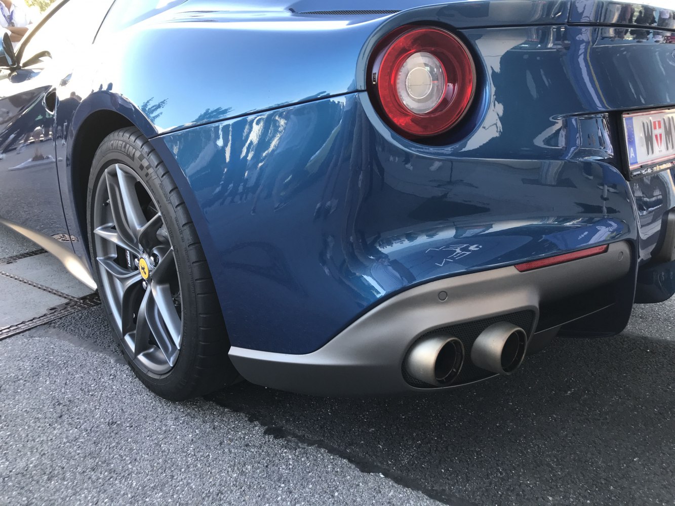 Close-up of rear round tail light and dual exhaust pipes
