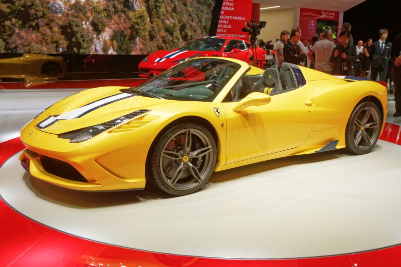 Yellow convertible with front racing stripes and distinctive alloy wheels.