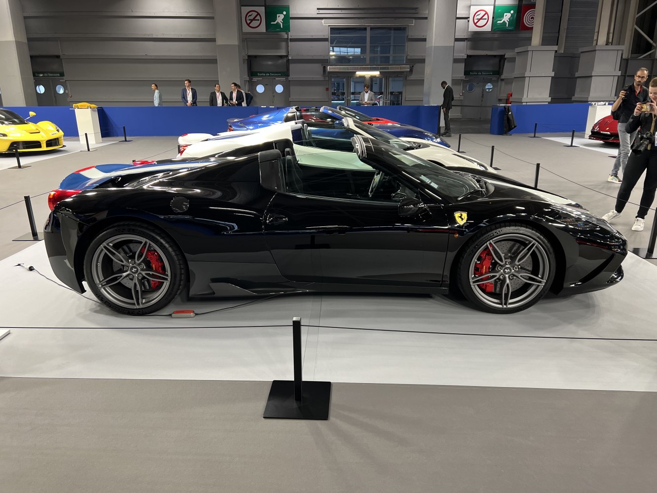 Convertible sports car side profile with alloy wheels and red brake calipers