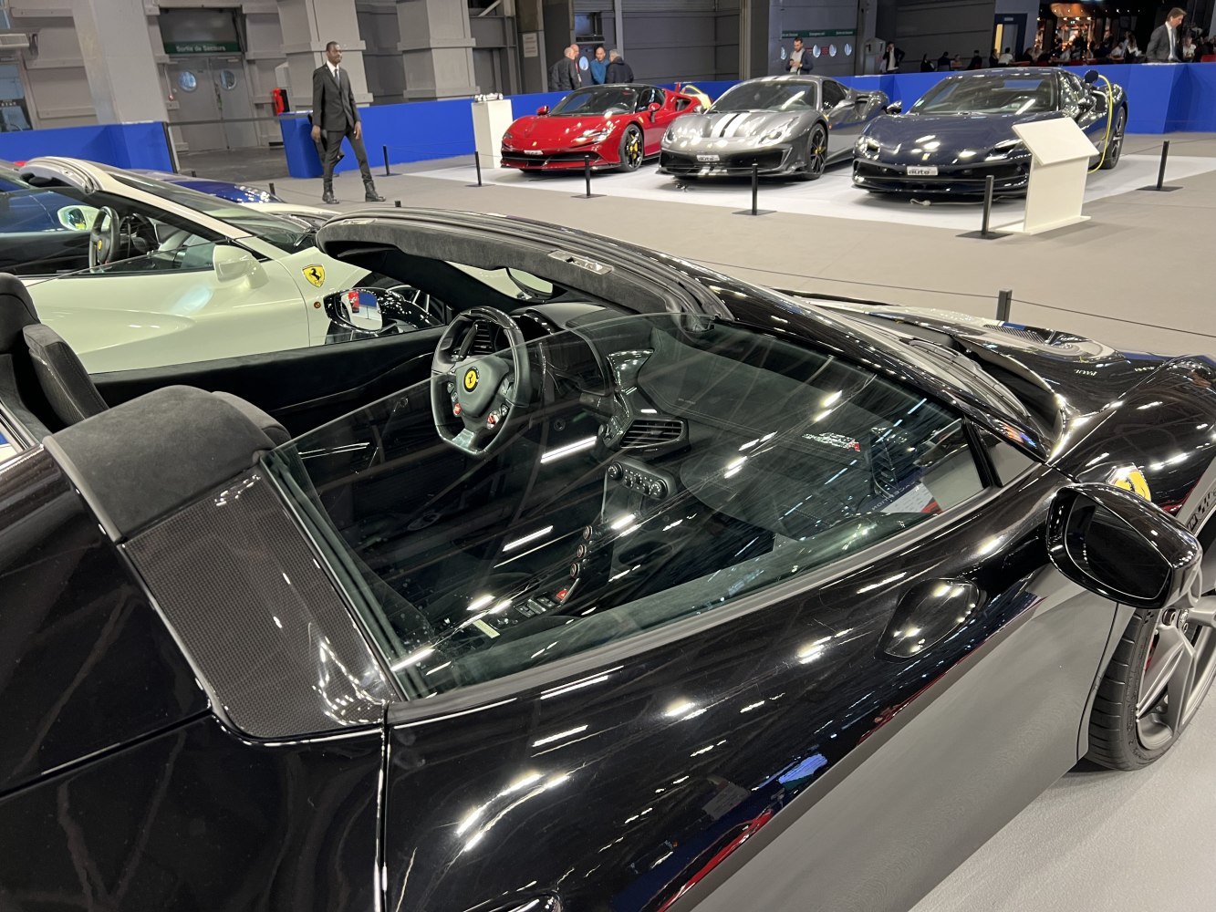 Interior and exterior details of a black luxury sports car.