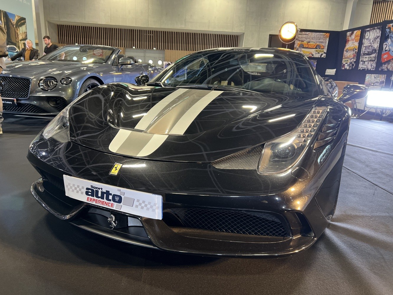 Front view of Ferrari 458 Speciale with white racing stripes and sleek headlights