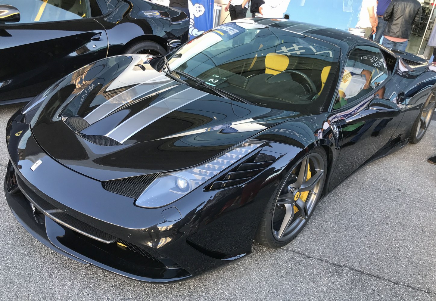 Black supercar with sporty hood vents and yellow brake calipers
