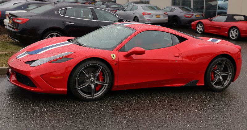Red sports coupe with racing stripe and alloy wheels