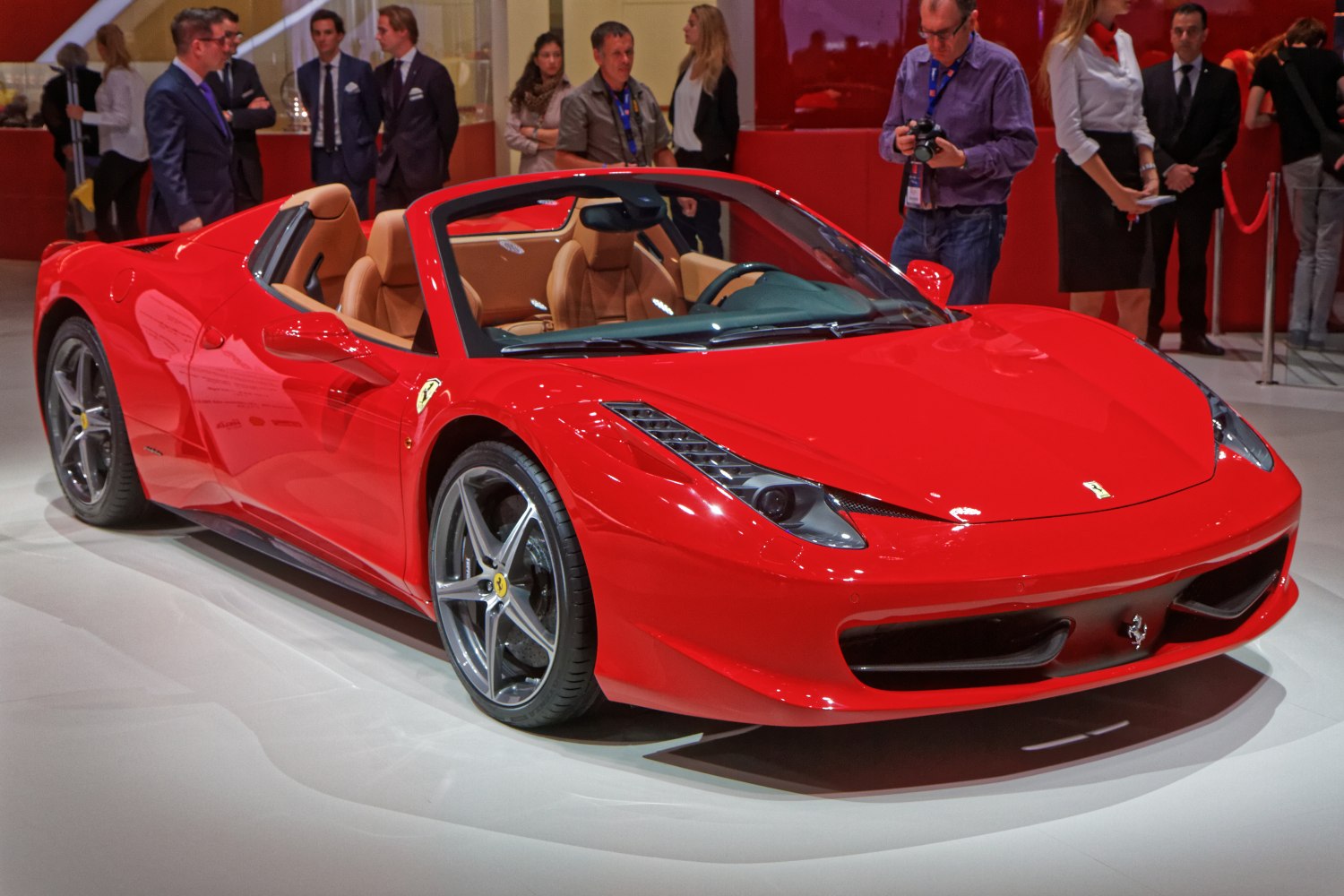 Red convertible sports car with leather seats and unique headlights