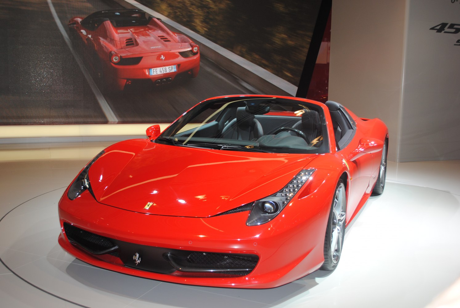 Red convertible sports car with sleek headlights and aerodynamic shape