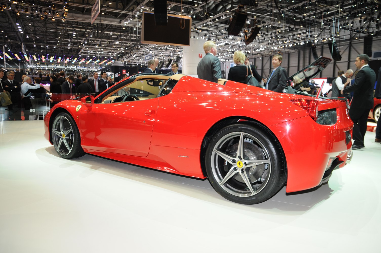 Red convertible sports car side profile with alloy wheels