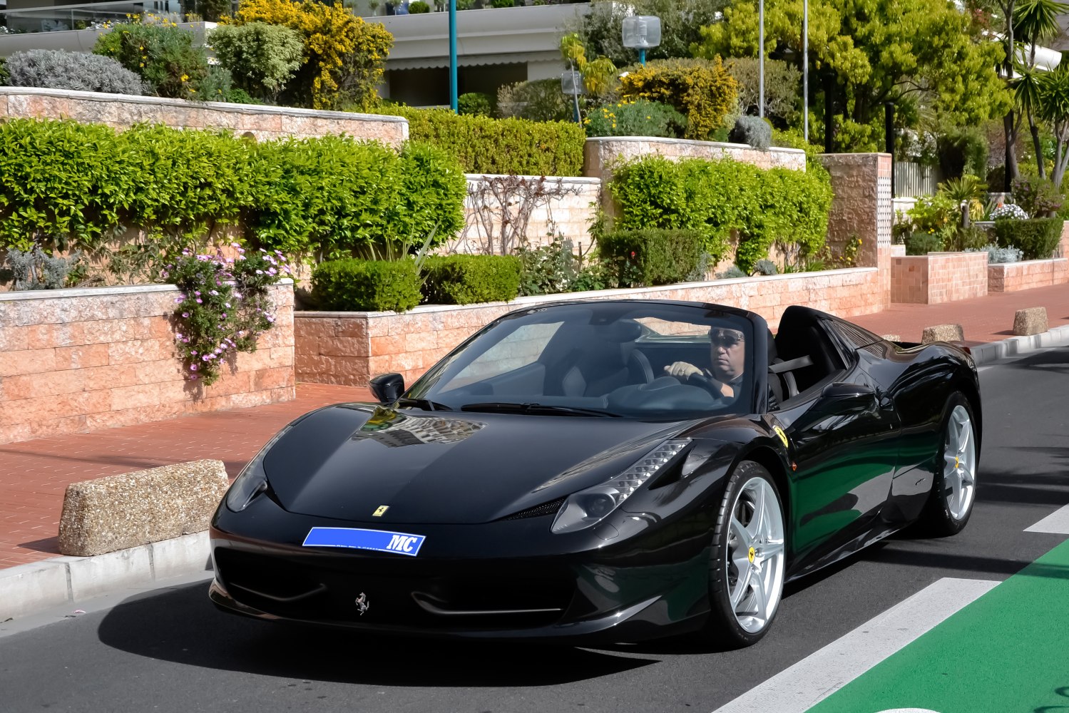 Black convertible sports car with sleek aerodynamic shape and open roof