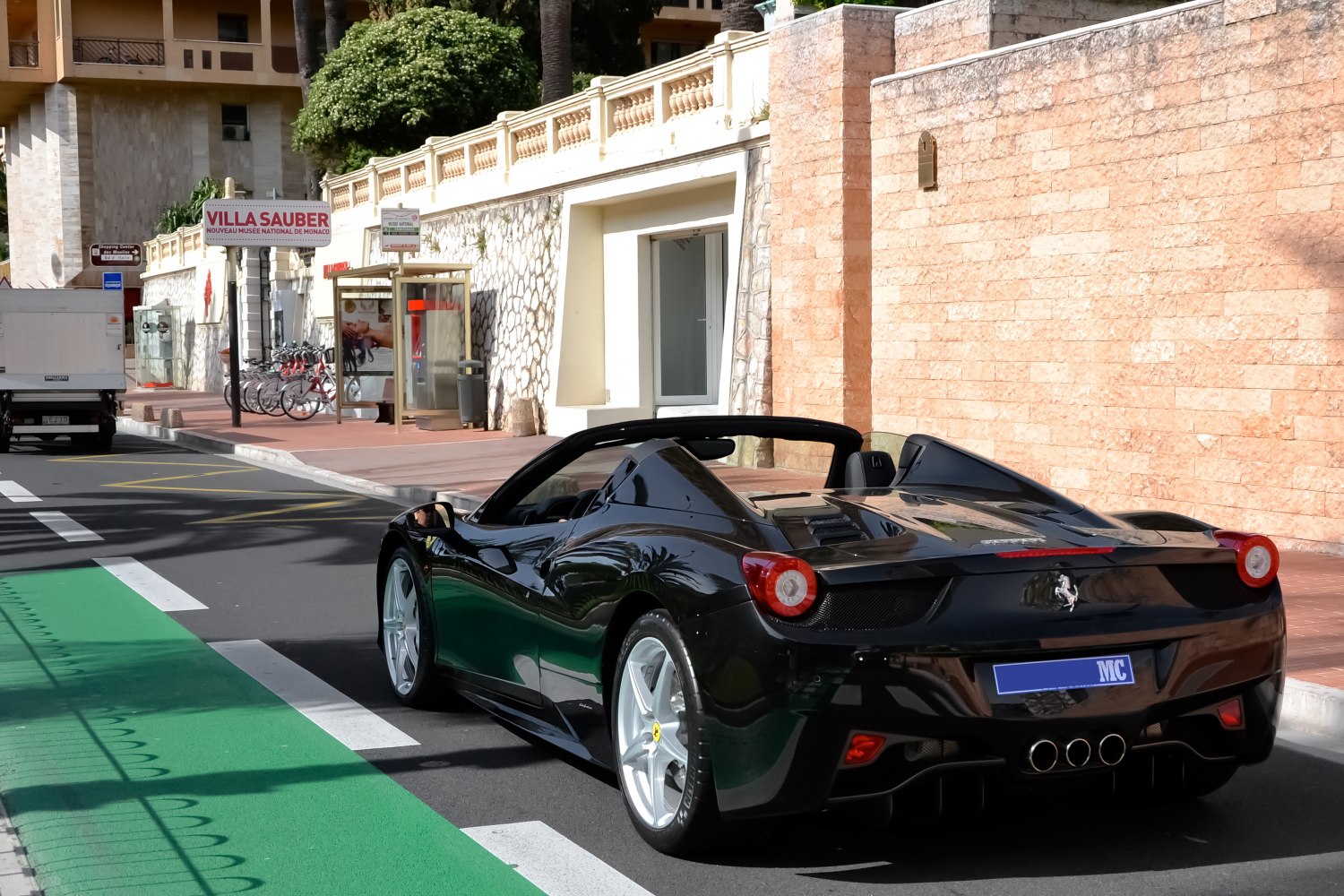 Rear view of convertible sports car in black with triple exhaust
