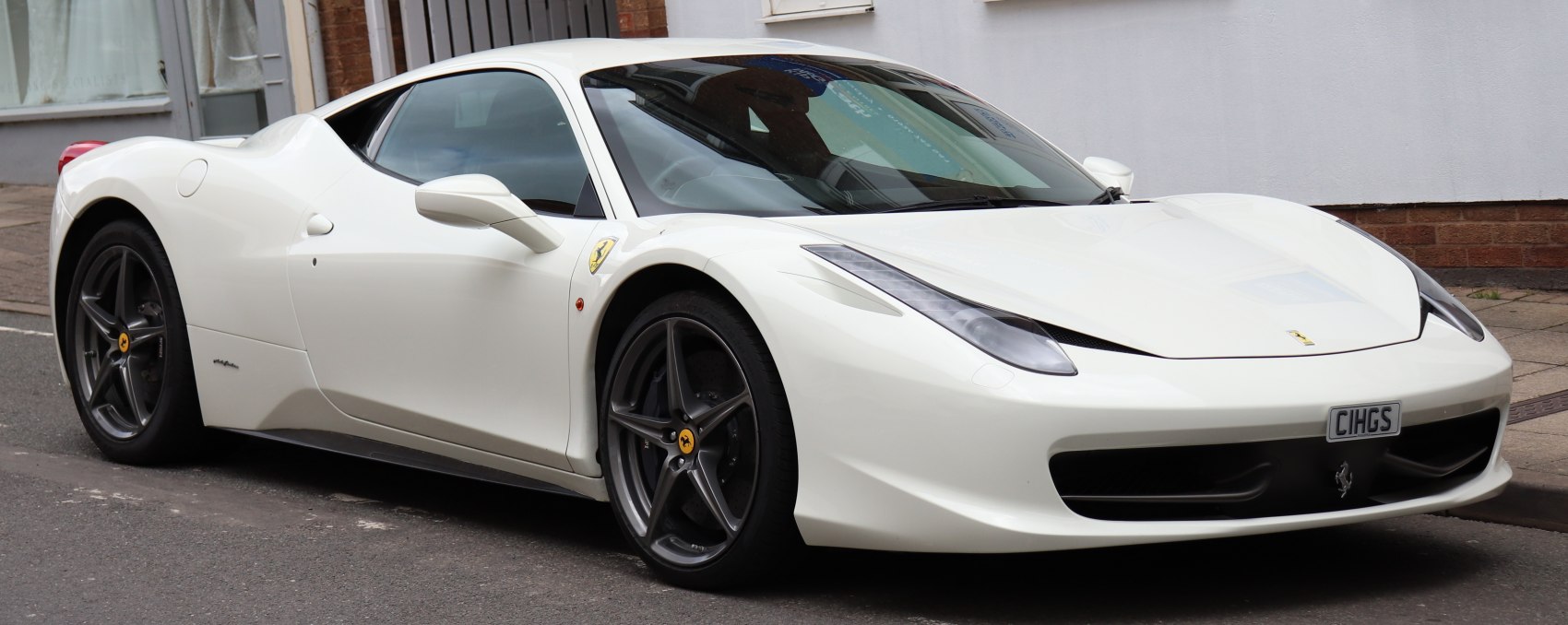 White sports car with aerodynamic shape and five-spoke rims