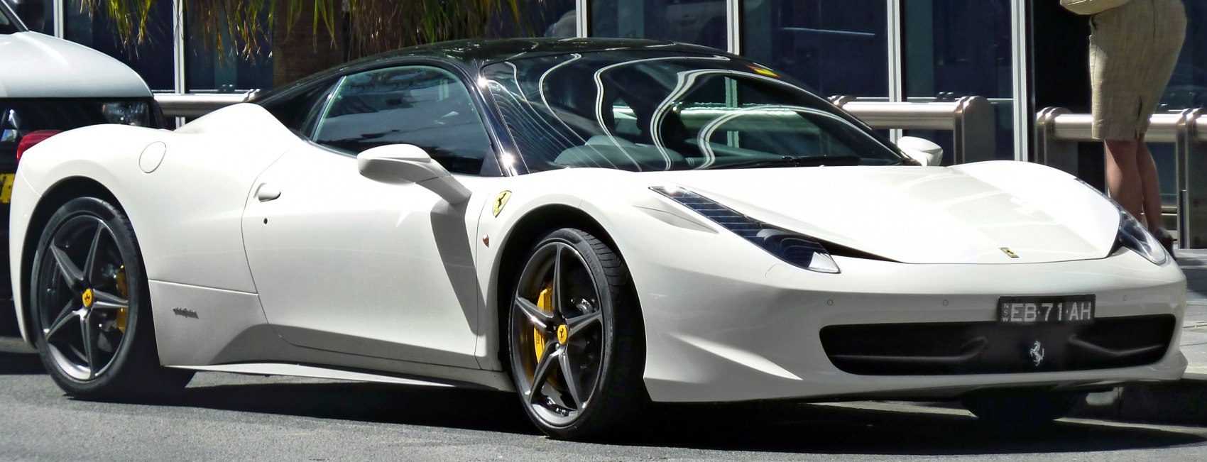 White Ferrari 458 Italia front and side aerodynamic design with alloy wheels