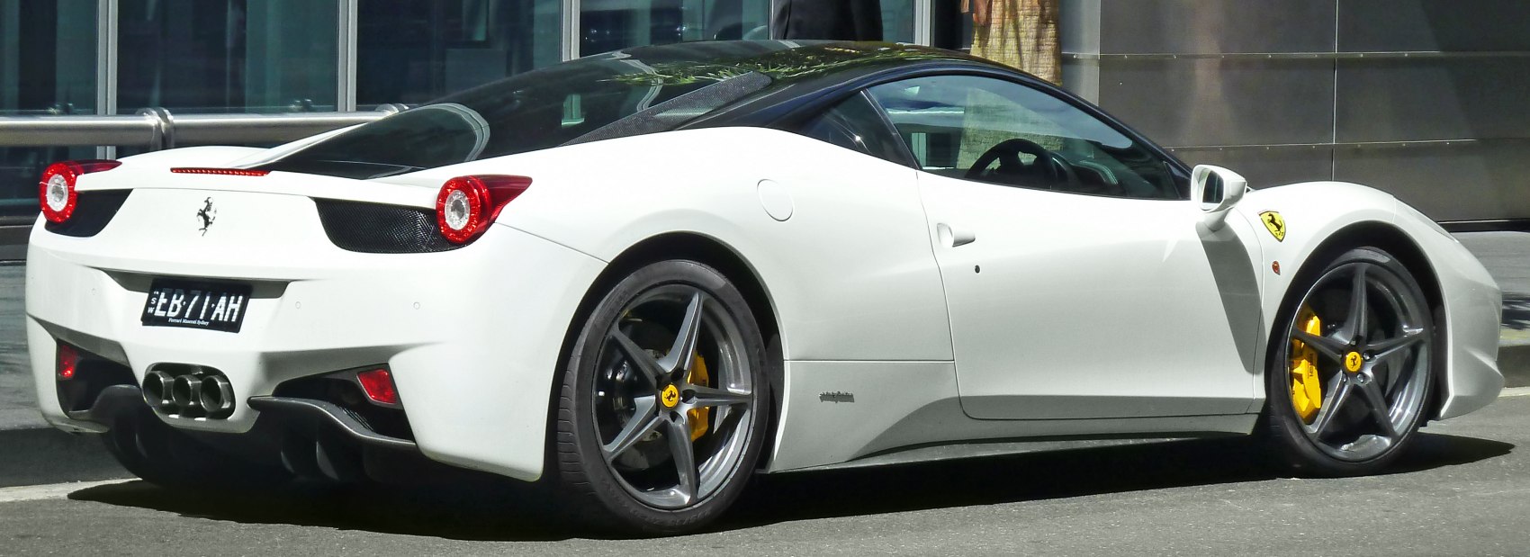 Rear side view of white Ferrari 458 Italia with yellow brake calipers