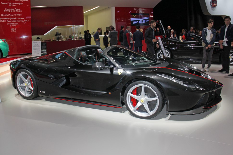 Black convertible supercar with five-spoke wheels and red brake calipers