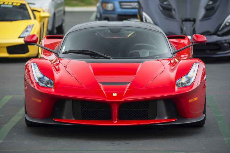 Front view of red high-performance supercar with aerodynamic front intakes